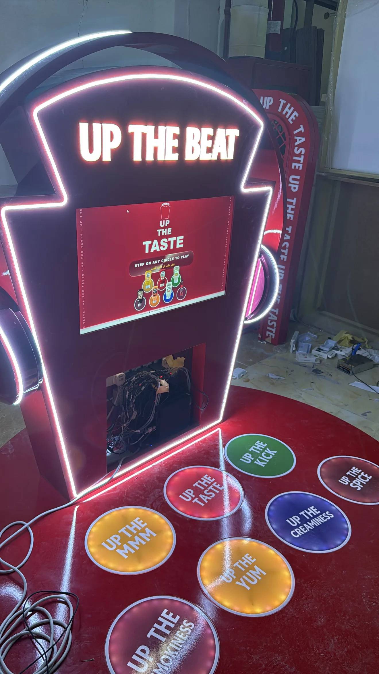 The lit floor ring and game screen during final assembly